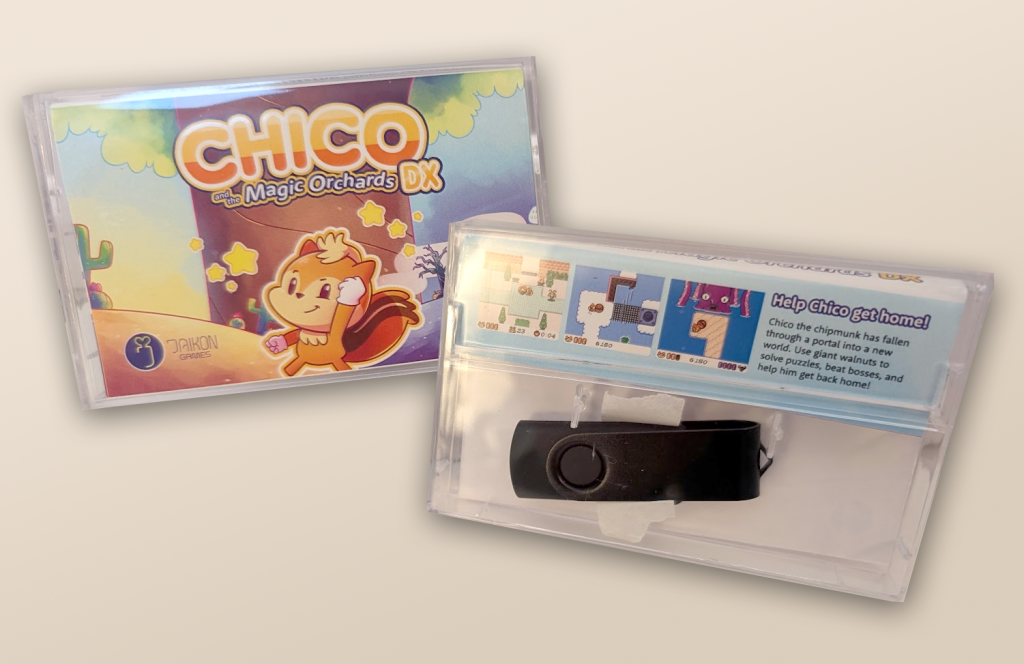 A photo of the new Chico DX physical cassette. It is a clear plastic cassette case with artwork inserted. The front shows Chico the Chipmunk in front of a colorful landscape, with the game's logo up top and a Daikon Games logo in the bottom-left. The rear of the case shows a few screenshots of the game and a short description, as well as a black USB stick which is visible inside the case